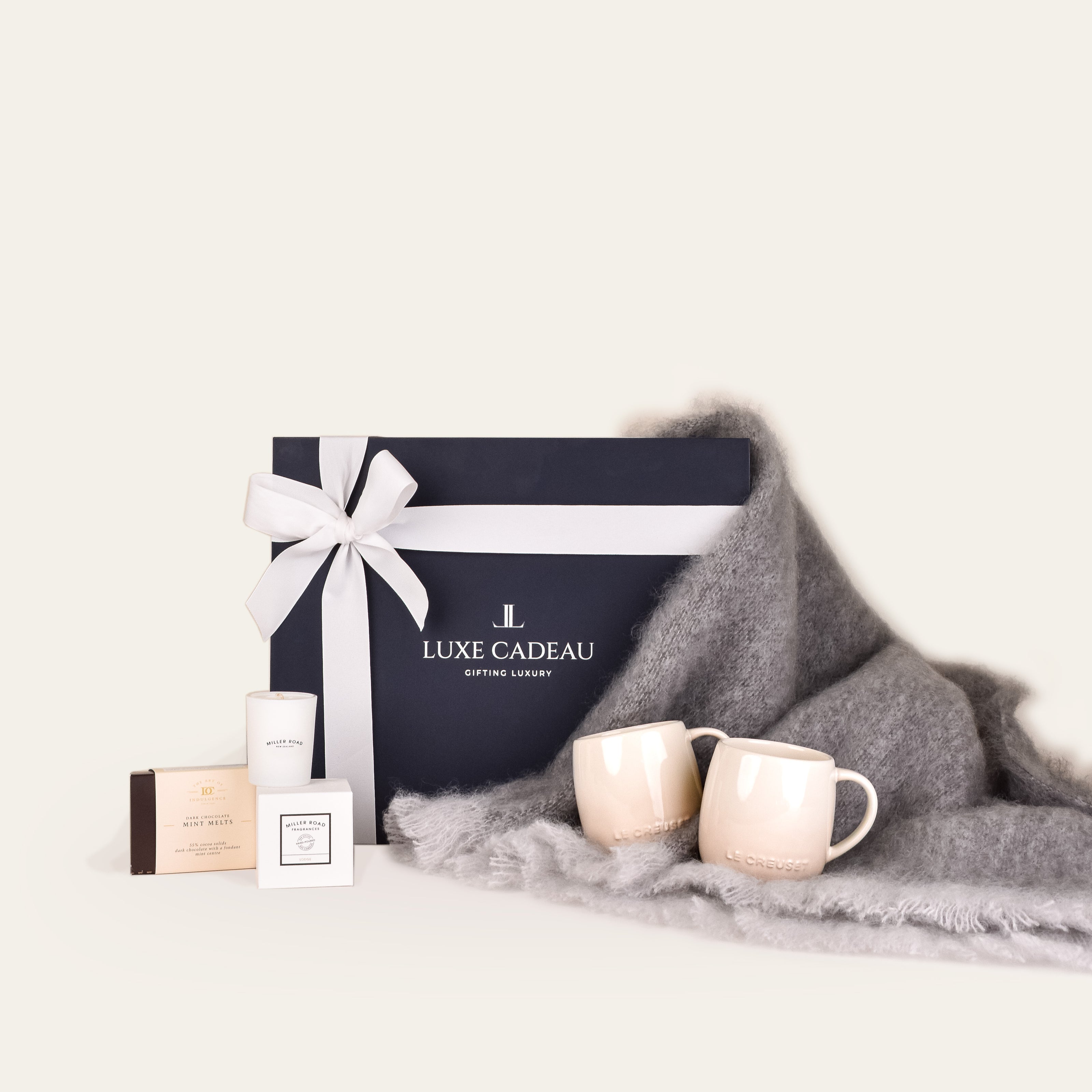 Luxe Cadeau Evening Hour gift box in navy packaging with a pewter mohair throw.
