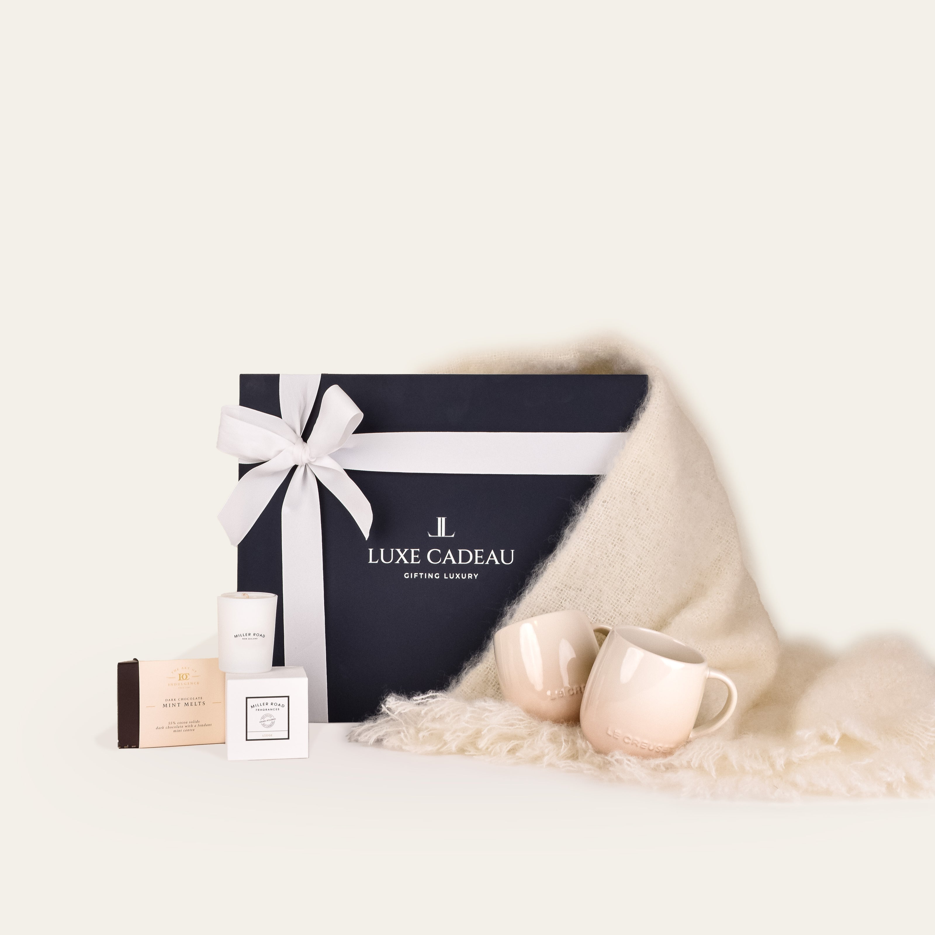 Luxe Cadeau Evening Hour gift box in navy packaging with a white mohair throw.
