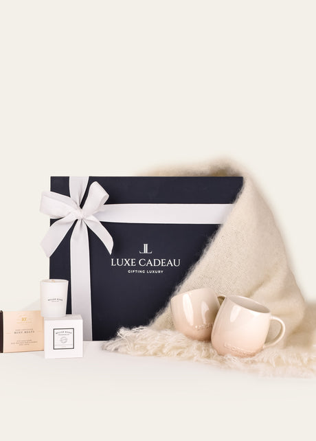 Luxe Cadeau Evening Hour gift box in navy packaging with a white mohair throw.
