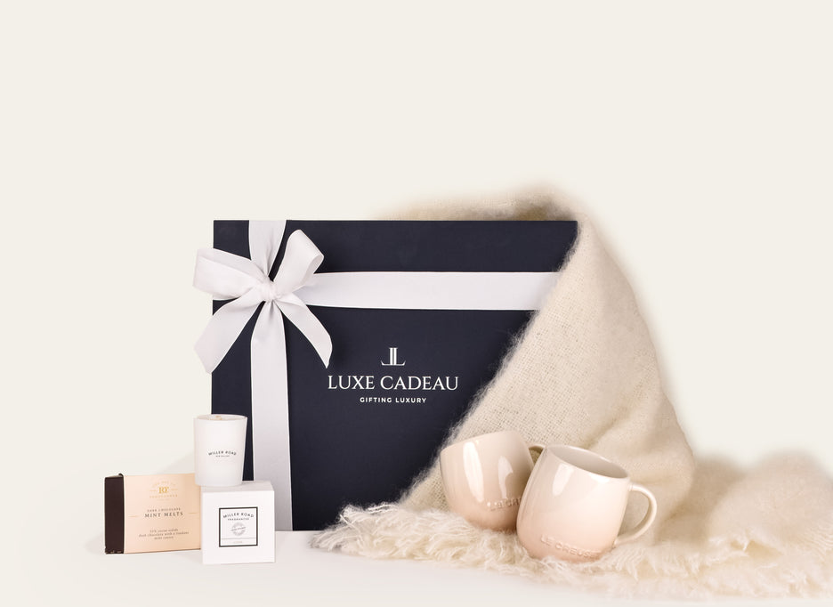 Luxe Cadeau Evening Hour gift box in navy packaging with a white mohair throw.
